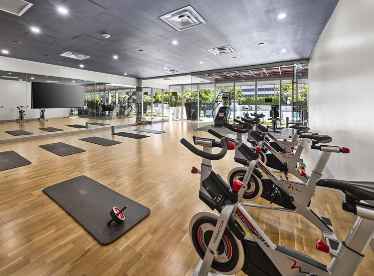 A gym with exercise bikes and yoga mats.